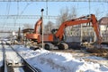 Rail excavator. Excavators machine excavate on railway. Construction of the underpass under the railway in winter. Russia