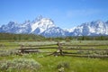 Rail fence in field below Grand Teton mountain ran