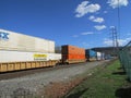 Rail road cars with intermodal containers of CSX, JB Hunt, Swift and Schneider passing by West Haverstraw, NY.