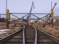 Rail road tracks under the gantry cranes on the berth of sea merchant port Royalty Free Stock Photo