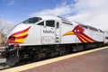 Rail Runner Express engine with distinctive red and yellow road runner bird design parked in railyard station,