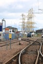Rail tracks near the port of Kotka and masts of large sailships Royalty Free Stock Photo