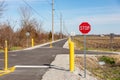 Multipurpose or multiuse bike trail with traffic barriers and stop sign.