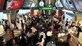 Rail Travellers Pass Through A Train Station