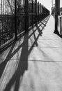 Railing shadow on the bridge. Bridge railing casts a shadow. Abstract bridge railing shadow Royalty Free Stock Photo