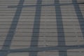 Railing shadow on wooden planks