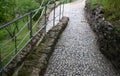 Cobblestone path with delimited edges granite cubes in a row and dividing channels from the cube trough channel due to rainwater Royalty Free Stock Photo