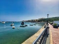 Railroad along the seashore. Beautiful sunset on the lake. Aerial photography of the beach. Sidewalk, pedestrians, wall and the