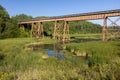 Railroad Bridge Over A Swampy Creek