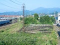 Railroad in the city against the backdrop of mountains. Many railway paths. Wagons and trains on the tracks. unloading station. Royalty Free Stock Photo