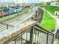 Railroad in the city. old, rusty road under the bridge. the railings of the bridge are painted with paint and overgrown with rust Royalty Free Stock Photo
