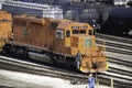 A railroad classification yard is filled with freight cars an engineer climbs aboard his road switcher Royalty Free Stock Photo
