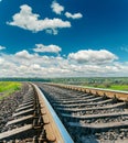 Railroad closeup and deep blue sky with clouds