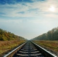 Railroad closeup goes to horizon under cloudy sky