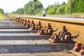 Railroad closeup. Railway tracks, Iron rusty train railway detail over dark stones. Royalty Free Stock Photo