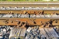 Railroad closeup. Railway tracks, Iron rusty train railway detail over dark stones. Royalty Free Stock Photo