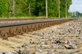 Railroad closeup. Railway tracks, Iron rusty train railway detail over dark stones Royalty Free Stock Photo