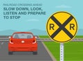 Railroad crossing ahead, slow down, look, listen and prepare to stop. Red car is reaching the level crossing.