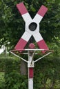 Railroad crossing without barrier, with warning sign and stop signal at an old railway line Royalty Free Stock Photo