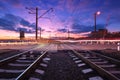 Railroad crossing with car lights in motion at night Royalty Free Stock Photo