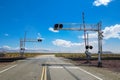 Railroad crossing gates on a road in the Mojave Desert Royalty Free Stock Photo