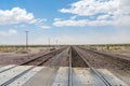 Railroad crossing gates on a road in the Mojave Desert Royalty Free Stock Photo