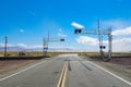 Railroad crossing gates on a road in the Mojave Desert Royalty Free Stock Photo