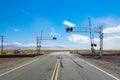 Railroad crossing gates on a road in the Mojave Desert Royalty Free Stock Photo