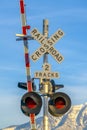 Railroad crossing sign with barrier and red lights