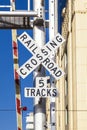 Railroad crossing sign with blue sky Royalty Free Stock Photo