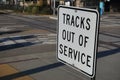 Railroad crossing sign indicates train tracks are inactive and out of service Royalty Free Stock Photo