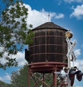 Railroad crossing sign and old water tower. Royalty Free Stock Photo