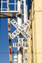 Railroad crossing sign under blue sky Royalty Free Stock Photo