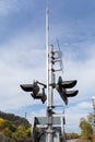 Railroad crossing signal and crossing bar silhouetted against a blue sky, train tracks running into the distance Royalty Free Stock Photo
