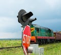 Railroad crossing signs and the approaching train Royalty Free Stock Photo