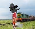 Railroad crossing signs and the approaching train Royalty Free Stock Photo