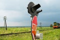 Railroad crossing signs and the approaching train Royalty Free Stock Photo