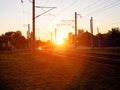 Railroad crossing on which cars ride in the background of the sun. Rail accident concept involving road transport, copy Royalty Free Stock Photo