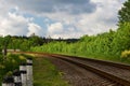 Railroad curve on summer bright cloudy day Royalty Free Stock Photo