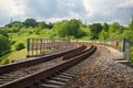 Railroad curve on summer bright cloudy day Royalty Free Stock Photo