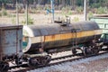 Railroad and freight train with rusty railway wagons going along forest. Transportain, cargo concept Royalty Free Stock Photo
