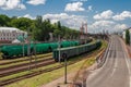 Railroad with freight wagons next to a highway Royalty Free Stock Photo