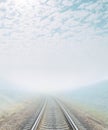 Railroad goes to foggy horizon Royalty Free Stock Photo