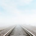 Railroad goes to horizon in fog Royalty Free Stock Photo
