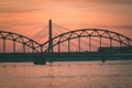 railroad metal bridge silhouette over river of Daugava in Riga,