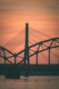 railroad metal bridge silhouette over river of Daugava in Riga,