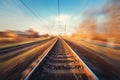 Railroad in motion at sunset. Blurred railway station Royalty Free Stock Photo