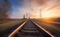 Railroad in motion at sunset. Blurred railway station Royalty Free Stock Photo