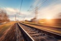 Railroad in motion at sunset. Blurred railway station Royalty Free Stock Photo