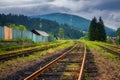 Railroad in mountains in overcast summer day